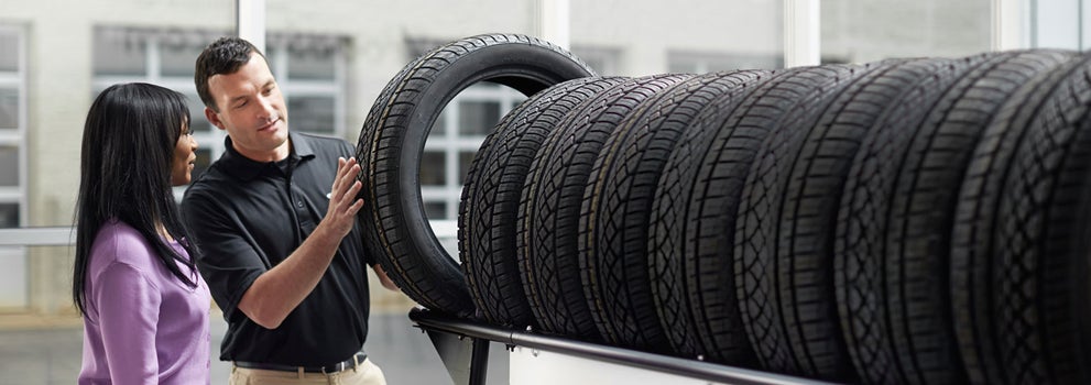 Subaru service representative showing customer a tire. | Royal Moore Subaru in Hillsboro OR