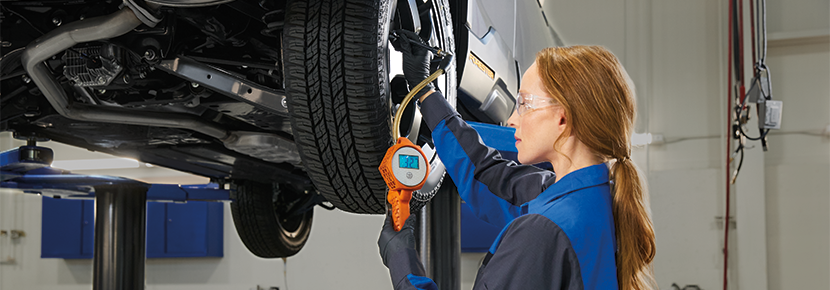 A Subaru technician checking tire pressure. | Royal Moore Subaru in Hillsboro OR