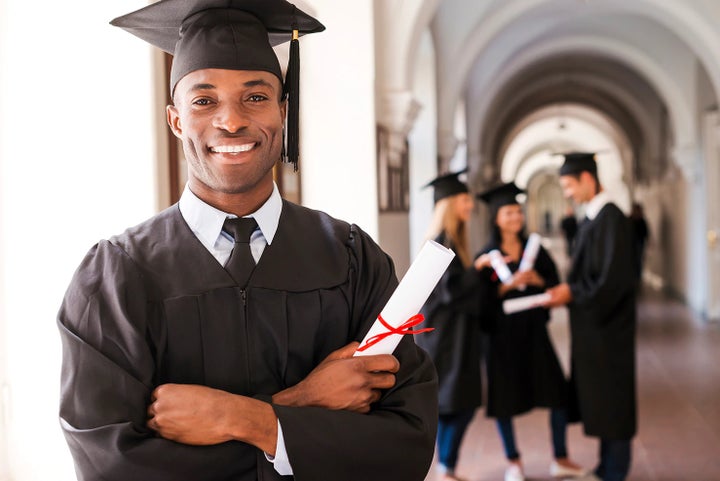 college graduate holding his diploma | Royal Moore Subaru in Hillsboro OR