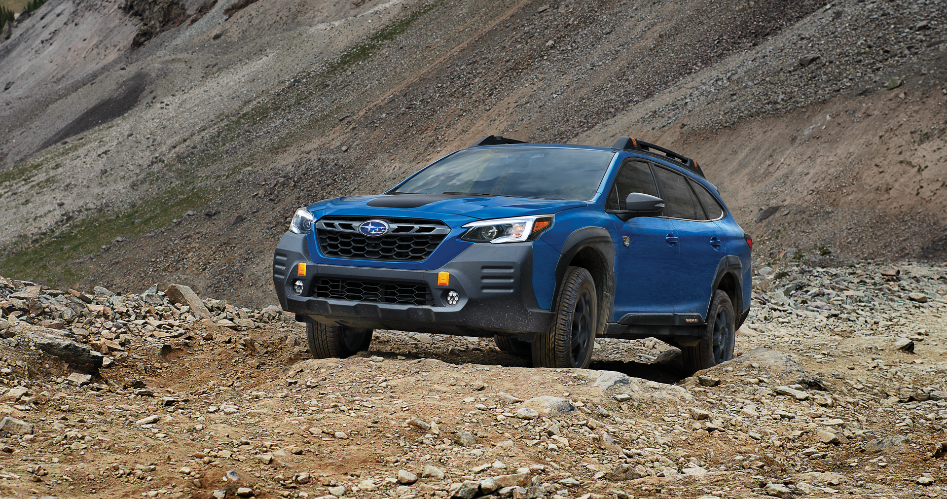 A 2023 Outback Wilderness driving on a trail in the mountains. | Royal Moore Subaru in Hillsboro OR