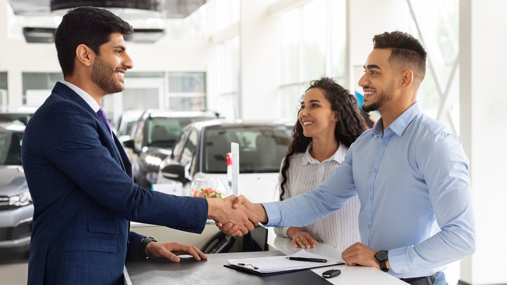 Happy couple buying their used Subaru